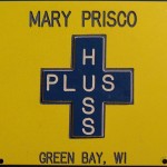 Yellow and blue Huss Plus badge