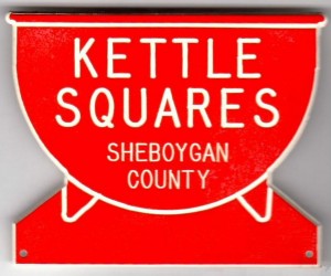 Red kettle-shaped badge with white lettering
